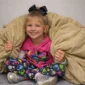 Child wrapped in sensory ball blanket for calming comfort