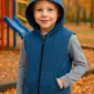 Child wearing blue weighted hoodie at playground