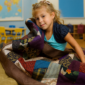 Young Girl in Classroom with Quilt