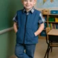 Child wearing blue weighted vest in classroom