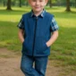 Child wearing a blue weighted sensory vest outdoors in a park.