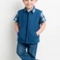 Child wearing blue weighted vest against white background